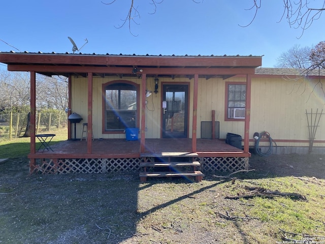 exterior space featuring covered porch and a front lawn