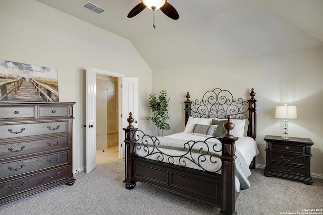 bedroom with visible vents, baseboards, light colored carpet, lofted ceiling, and ensuite bath