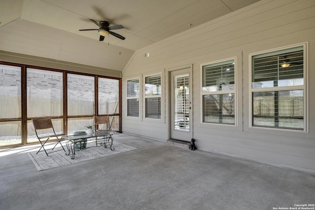 unfurnished sunroom with lofted ceiling, ceiling fan, and plenty of natural light