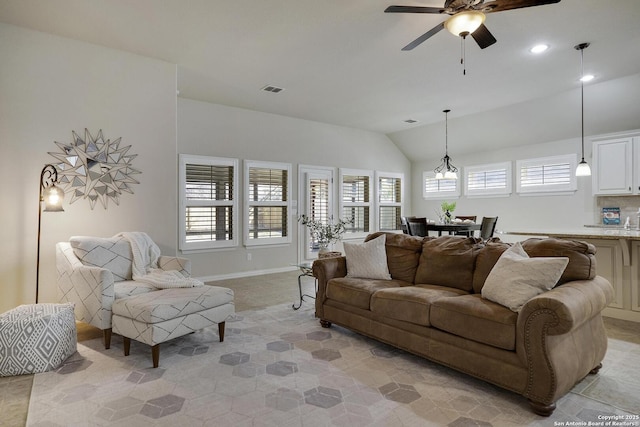 living area with recessed lighting, visible vents, vaulted ceiling, ceiling fan, and baseboards