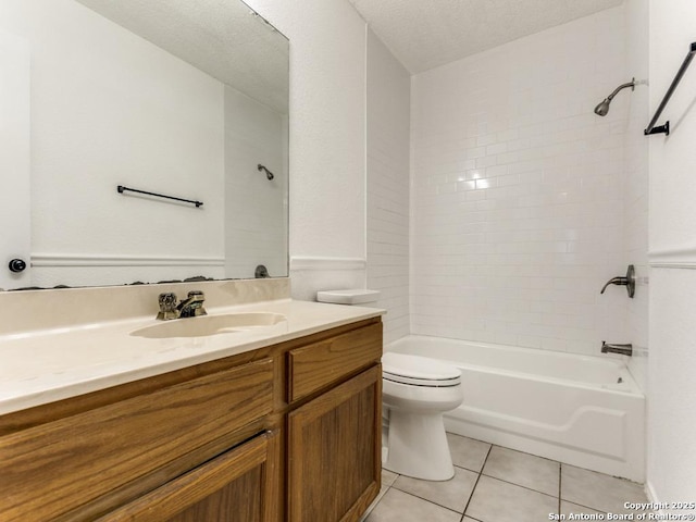 full bathroom with toilet, a textured ceiling, vanity, tiled shower / bath combo, and tile patterned flooring