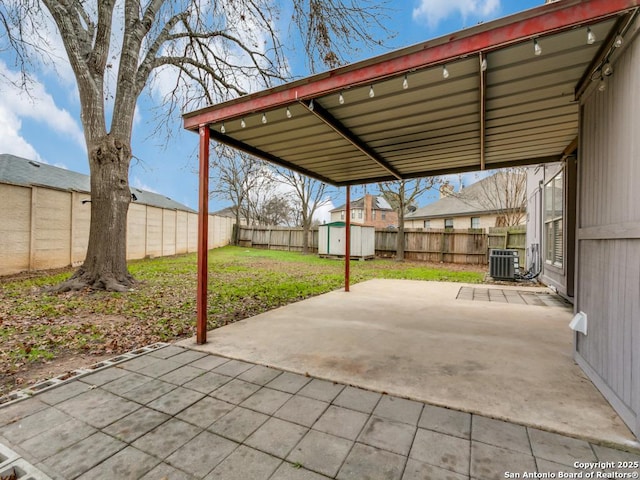 view of patio featuring central AC and a storage unit