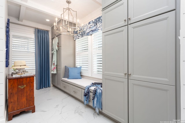 mudroom featuring ornamental molding and a notable chandelier