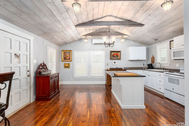 kitchen with wood counters, decorative light fixtures, white cabinetry, a center island, and white appliances