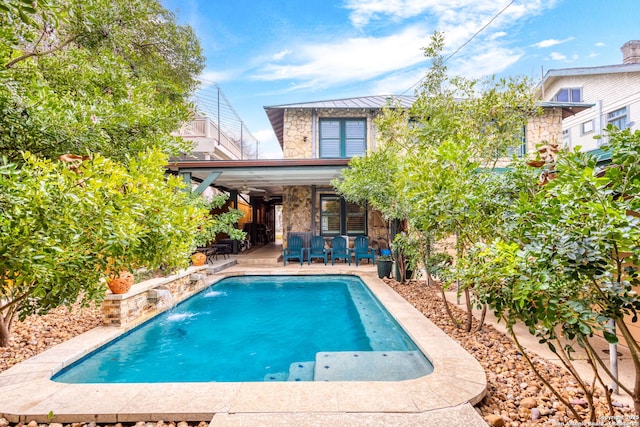 view of pool featuring a patio area and pool water feature