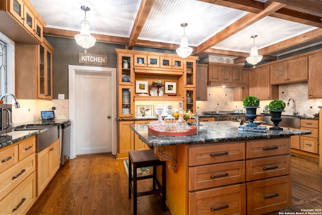 kitchen featuring pendant lighting, stainless steel dishwasher, dark hardwood / wood-style floors, and a kitchen island