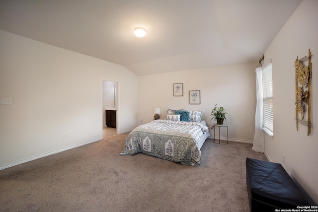 bedroom with lofted ceiling and carpet flooring