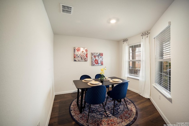 dining space with dark hardwood / wood-style floors