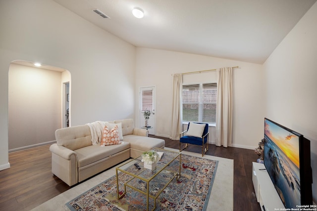 living room with dark hardwood / wood-style flooring and high vaulted ceiling