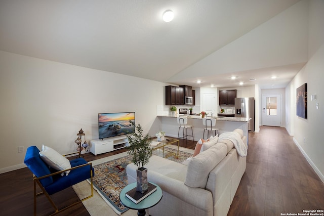 living room with dark hardwood / wood-style flooring and high vaulted ceiling