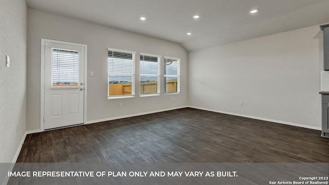 unfurnished living room featuring dark wood-type flooring, plenty of natural light, and vaulted ceiling