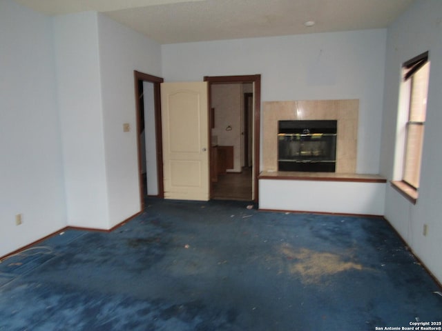 unfurnished living room with a fireplace and a healthy amount of sunlight