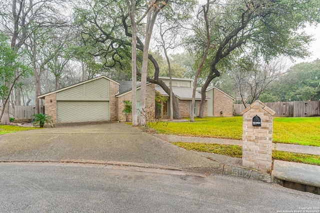 view of front of house featuring a garage and a front lawn