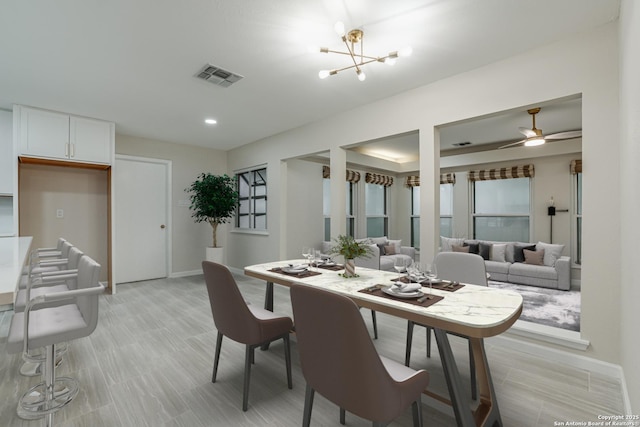 dining space featuring an inviting chandelier and a raised ceiling