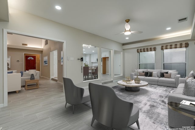 living room featuring ceiling fan and light hardwood / wood-style flooring