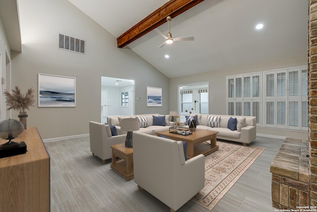 living room featuring beamed ceiling, ceiling fan, light wood-type flooring, and high vaulted ceiling