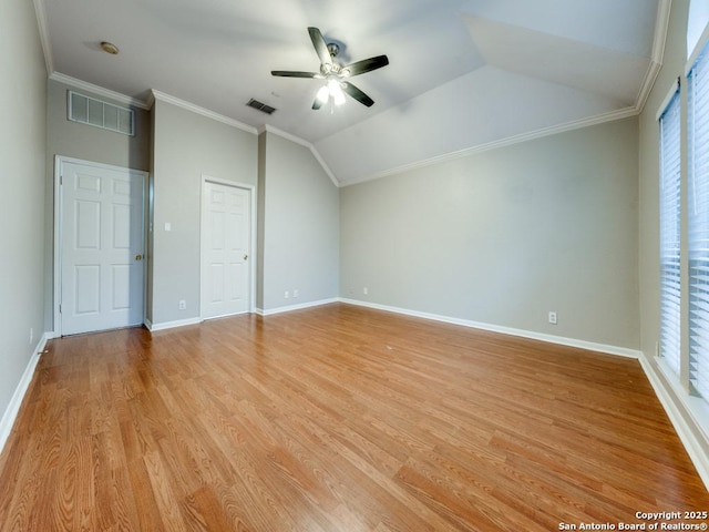 interior space featuring crown molding, lofted ceiling, and light hardwood / wood-style flooring