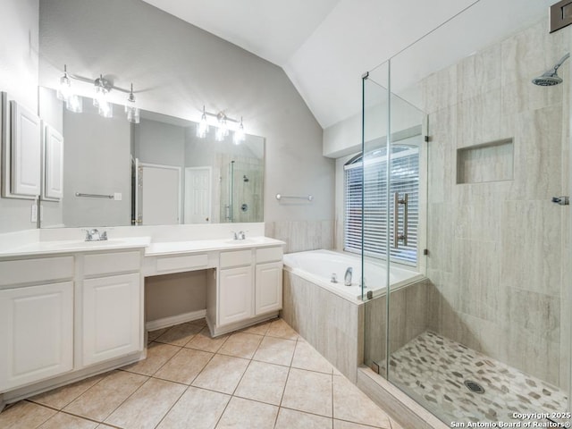 bathroom featuring tile patterned flooring, shower with separate bathtub, lofted ceiling, and vanity