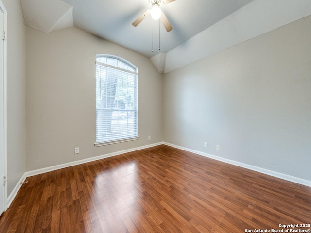 empty room with lofted ceiling, hardwood / wood-style floors, and ceiling fan