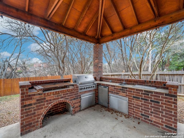 view of patio / terrace featuring sink, grilling area, and exterior kitchen