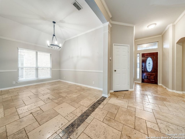 foyer entrance featuring an inviting chandelier and crown molding