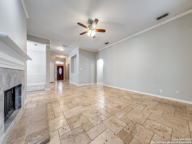 unfurnished living room with a high end fireplace, ornamental molding, and ceiling fan