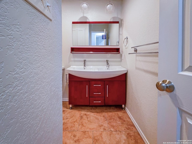 bathroom with tile patterned floors and vanity