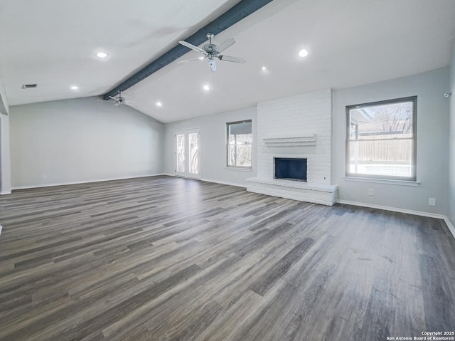 unfurnished living room featuring vaulted ceiling with beams, a fireplace, dark hardwood / wood-style floors, and ceiling fan