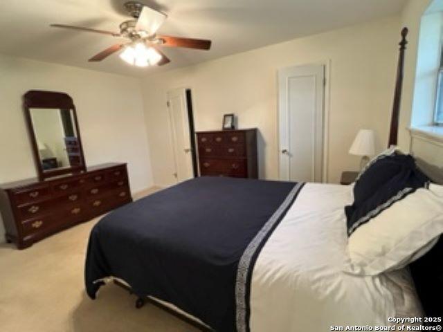 bedroom featuring light colored carpet and ceiling fan