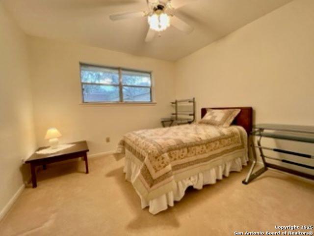 bedroom featuring ceiling fan and carpet