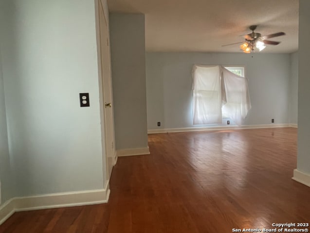 spare room with ceiling fan and dark hardwood / wood-style flooring