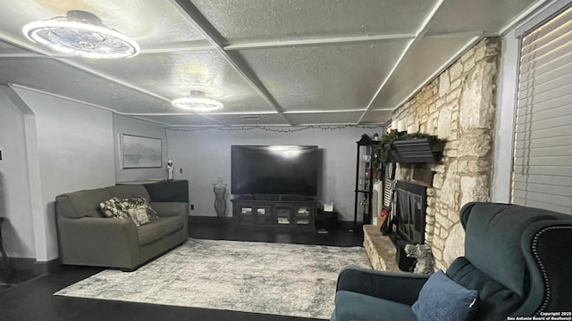 living room featuring a stone fireplace