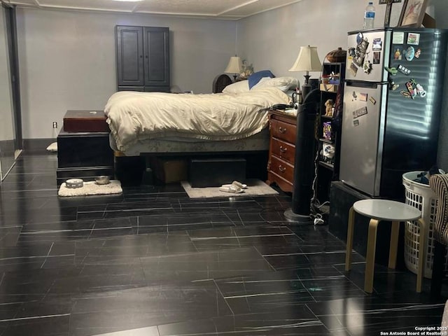 bedroom featuring stainless steel fridge