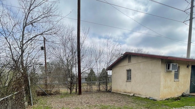 view of home's exterior featuring a wall mounted air conditioner