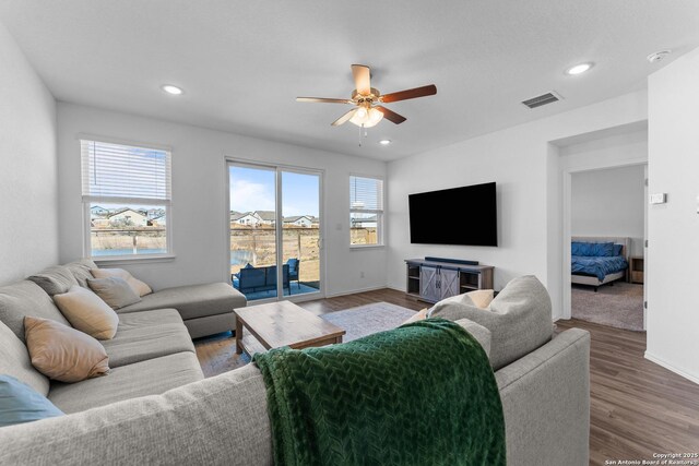 living room featuring hardwood / wood-style floors and ceiling fan