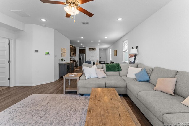 living room featuring dark hardwood / wood-style floors and ceiling fan