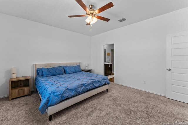 carpeted bedroom with ceiling fan and connected bathroom