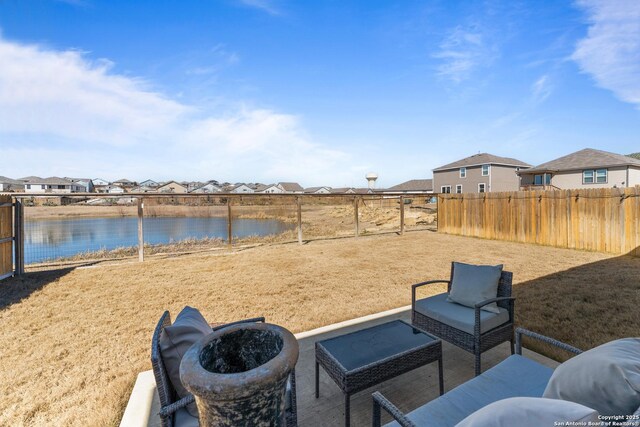 view of patio / terrace with a water view and an outdoor fire pit