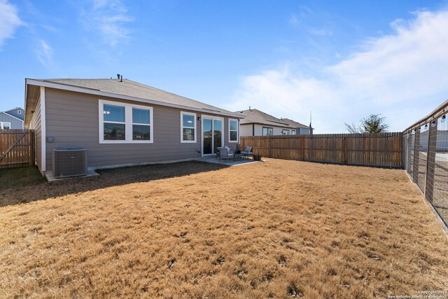 rear view of property with a yard, a patio area, and central air condition unit