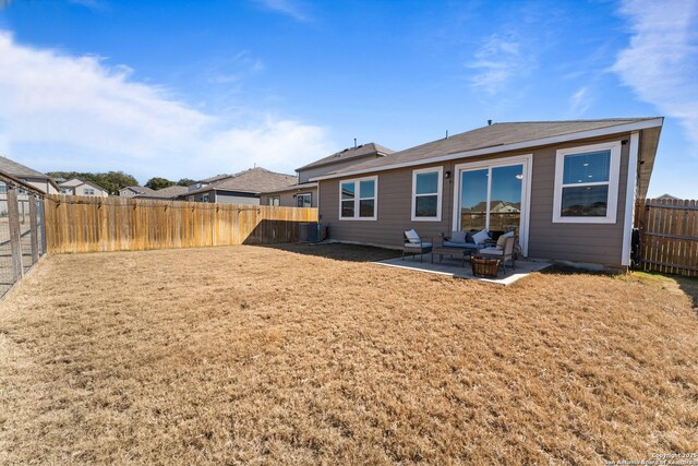 back of house with cooling unit, a yard, and a patio