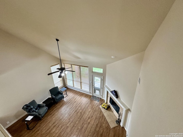 living room with a tiled fireplace and light hardwood / wood-style flooring