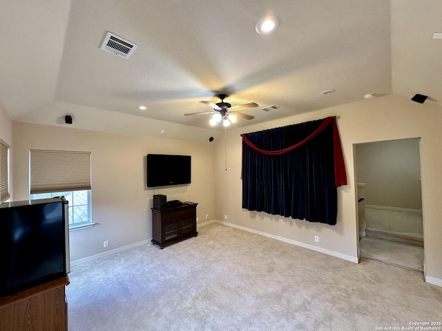 unfurnished living room featuring light colored carpet and ceiling fan