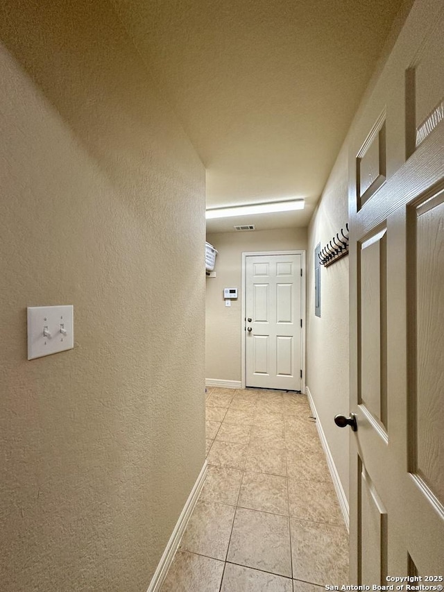 corridor featuring light tile patterned floors