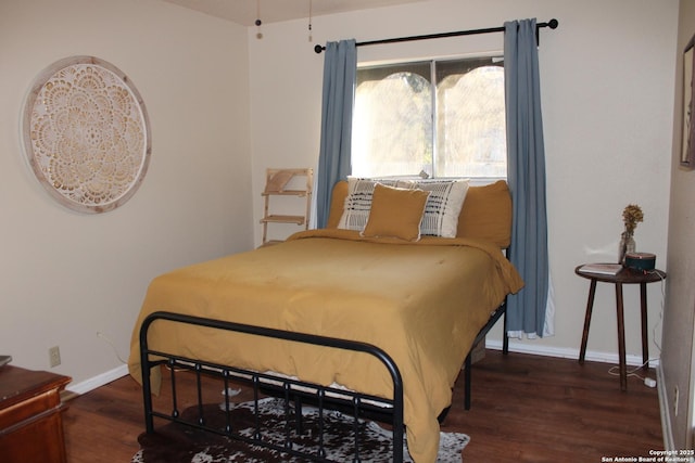 bedroom with dark hardwood / wood-style flooring