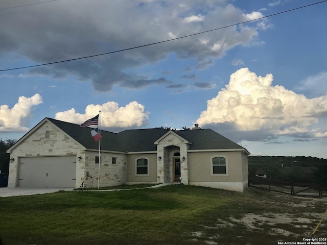 view of front of property with a garage and a front lawn