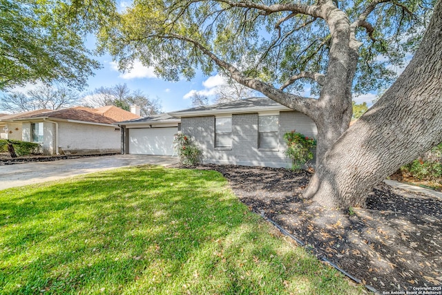 ranch-style home with a garage and a front yard