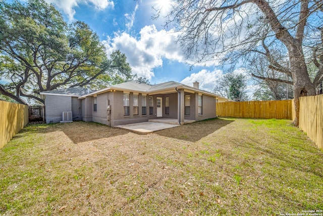 back of property featuring a patio area, a lawn, and central air condition unit