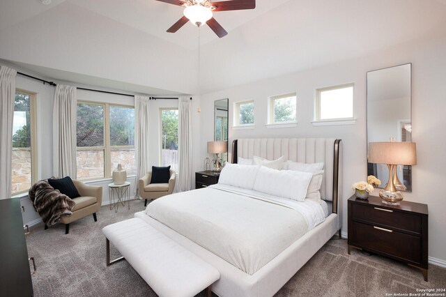 bedroom featuring ceiling fan, lofted ceiling, and dark carpet