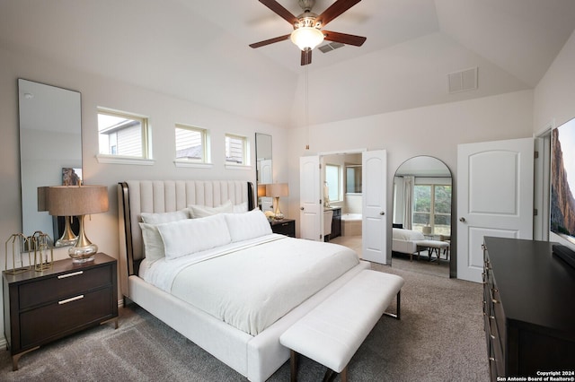 carpeted bedroom with ceiling fan, lofted ceiling, and connected bathroom