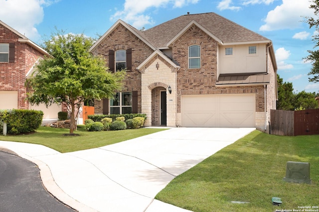 view of front of property featuring a garage and a front lawn